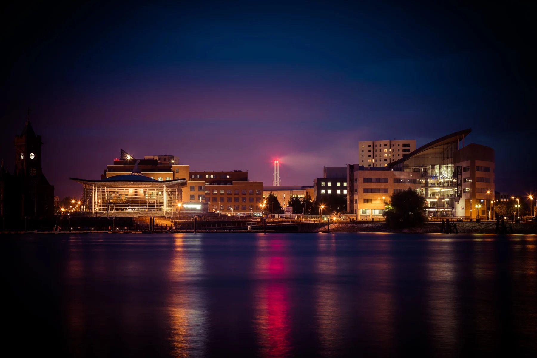 The waterfront and Senedd building in Cardiff Bay at dusk