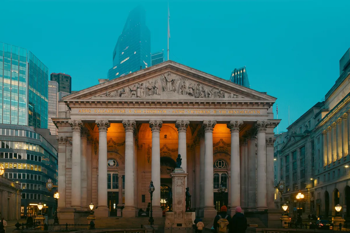 The Royal Exchange in the City of London at dusk, with office towers behind