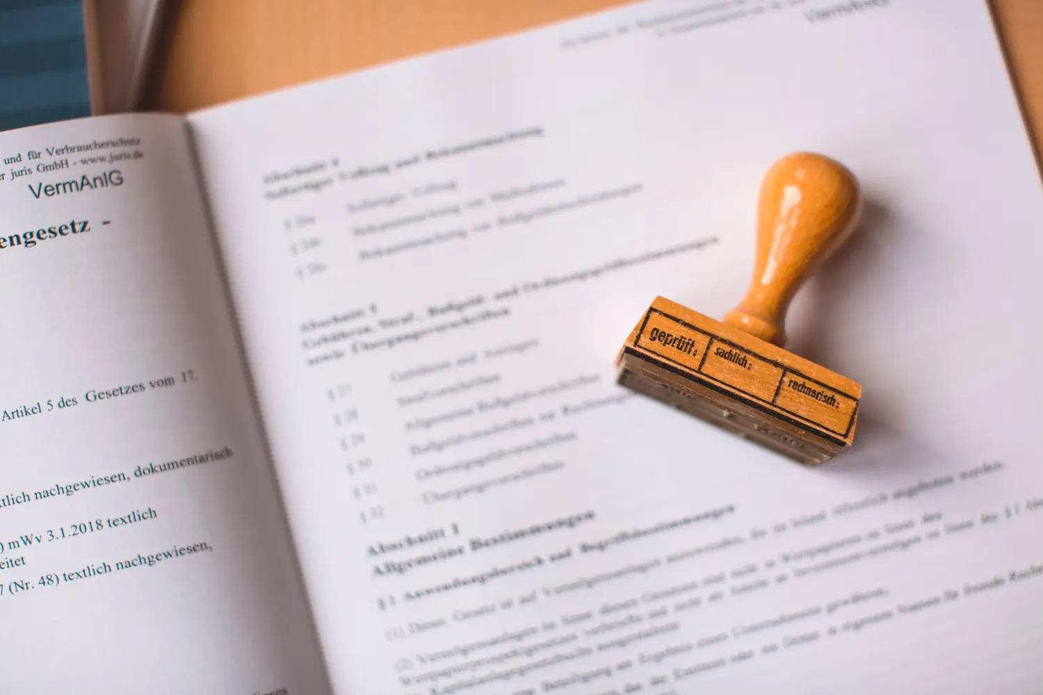 A legal text with an official rubber stamp resting on the page