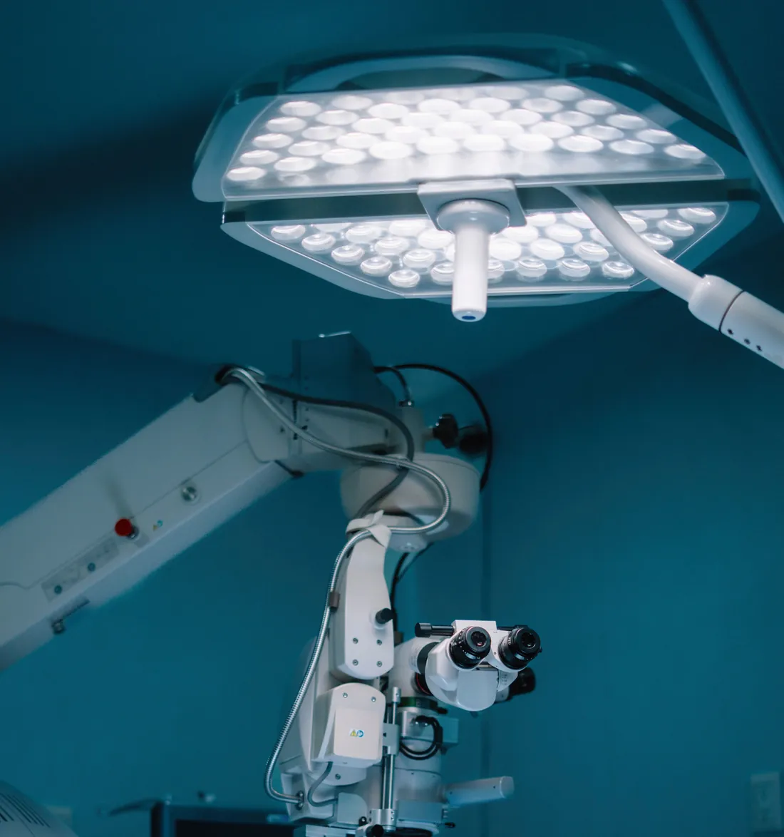 An operating-theatre lamp and a surgical microscope in a modern hospital theatre